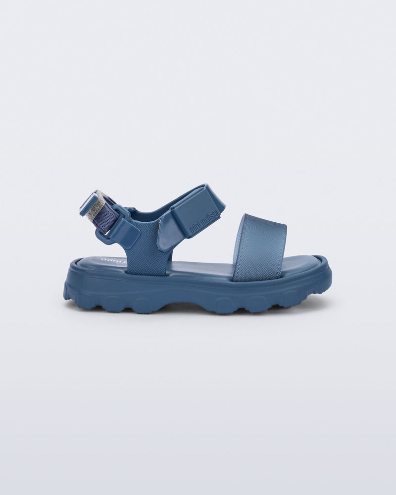 Side view of a blue baby Kick Off Sandal