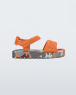 Side view of a orange baby Imagine sandal