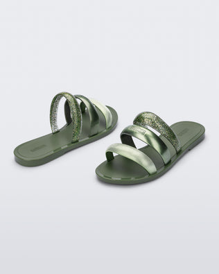 Back and angled view of a pair of green Eclipse Slides with glitter green straps.