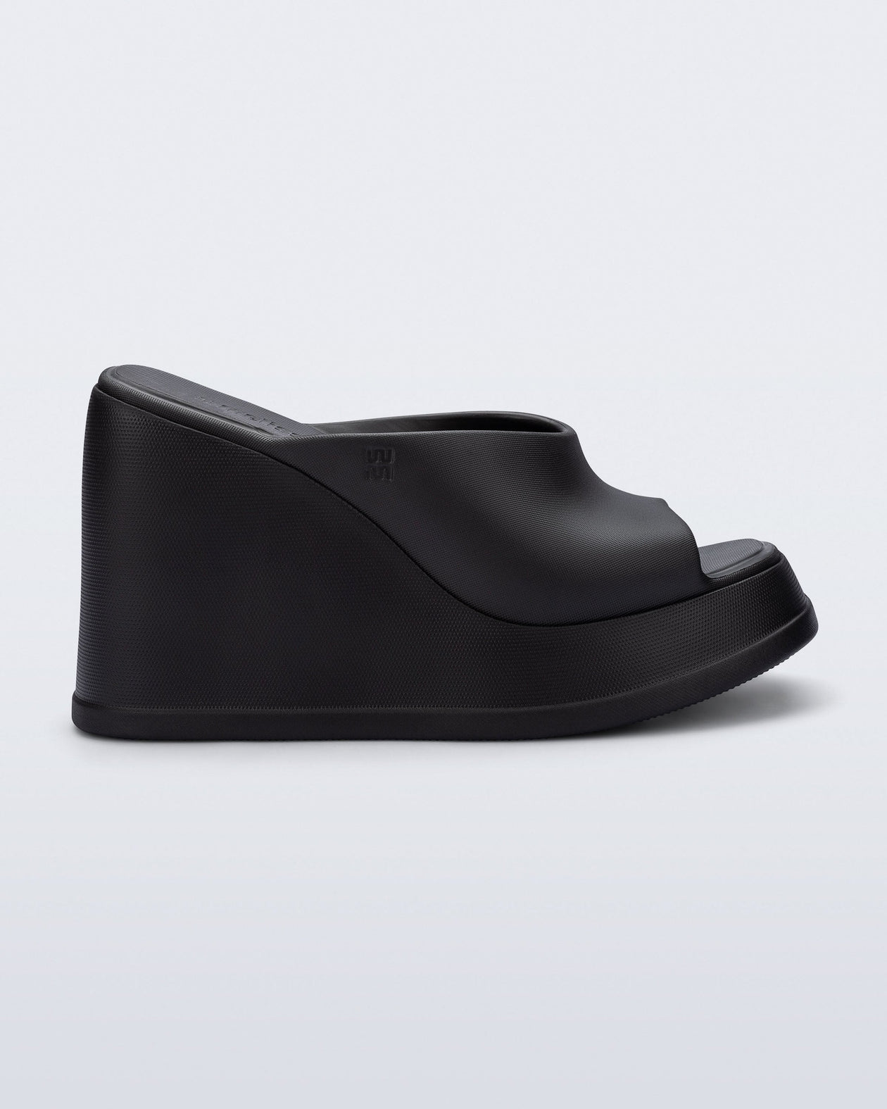 Side view of a black Free Slip platform wedge heel