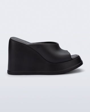 Side view of a black Free Slip platform wedge heel