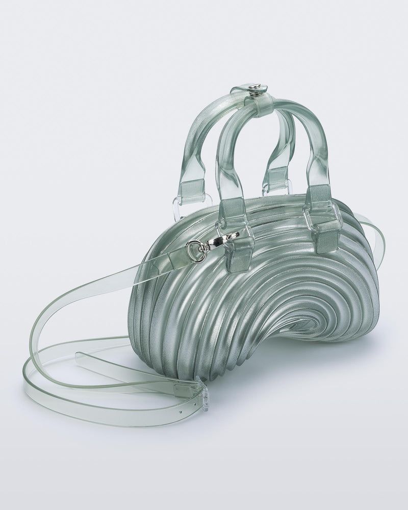 Angled view of a transparent blue Quantum Dome + Diesel bag with hand strap and shoulder strap