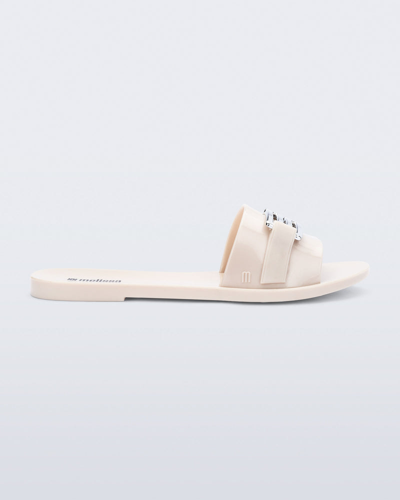 Side view of a beige Babe M Chic slide sandal
