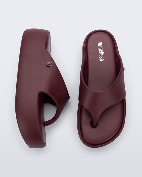 Side and Top view of a pair of burgundy Free Platform Thong sandals