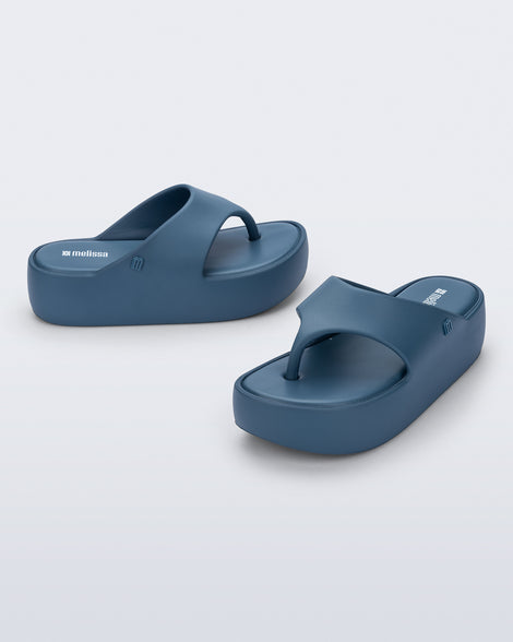 Side and angled view of a pair of blue Free Platform Thong sandals