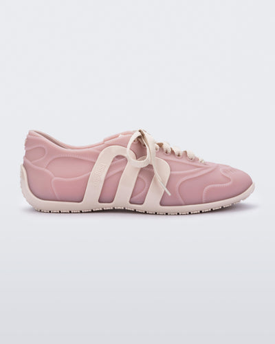 Side view of a pink/beige Motion sneaker