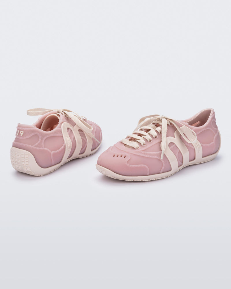 Back and angled view of a pair of pink/beige Motion sneakers