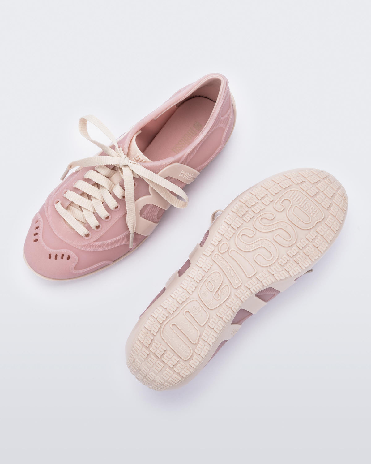 Top and bottom view of a pair of pink/beige Motion sneakers