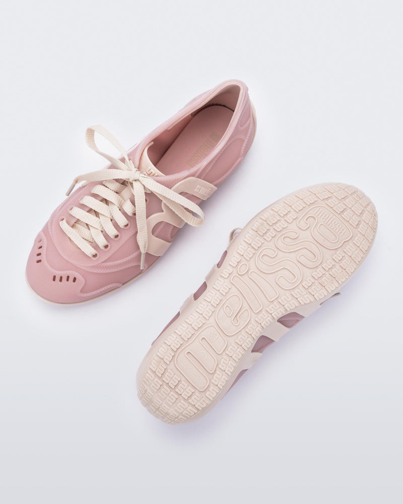 Top and bottom view of a pair of pink/beige Motion sneakers
