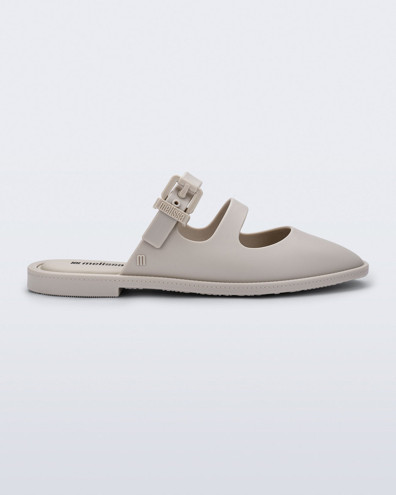 Side view of a matte beige Anastasia slide mule