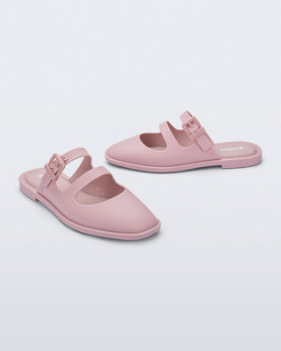 Side and angled view of a pair of matte pink Anastasia slides