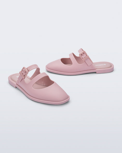Side and angled view of a pair of matte pink Anastasia slides