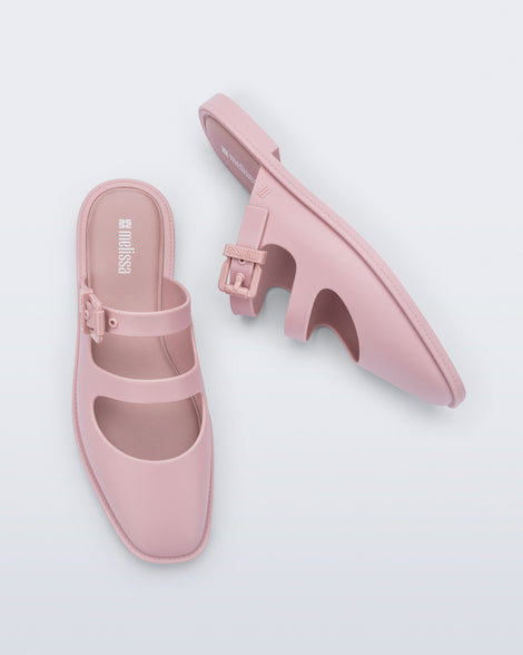 Top and side view of a pair of matte pink Anastasia slides