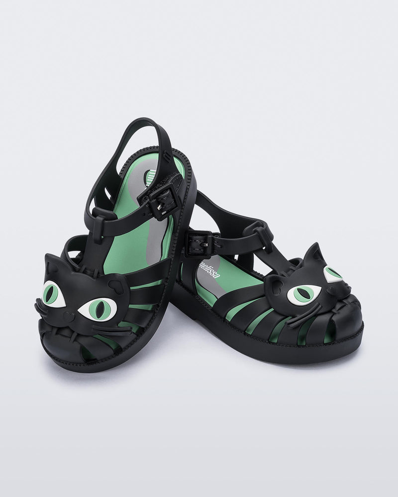 Angled view of a pair of orange baby Possession Cat sandals