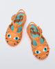 Top view of a pair of orange baby Possession Cat sandals