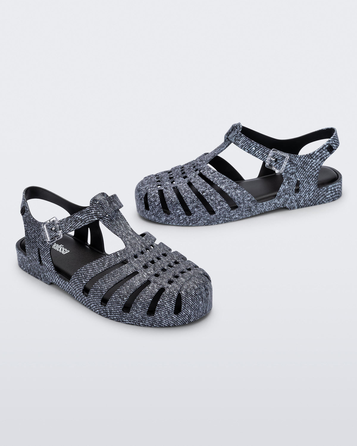 Angled view of a pair of black jean Possession sandals