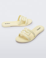 Angled view of a pair of beige M Slides.