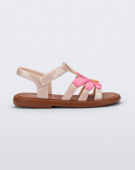 Side view of a pink Hip Bloom kids sandal with pink flower