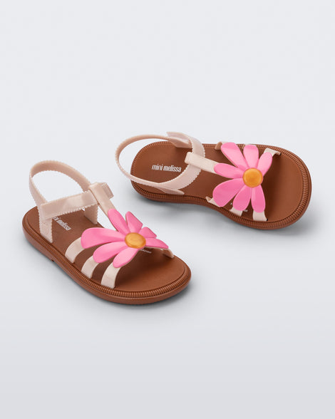 Top and angled view of a pair of pink Hip Bloom kids sandals with pink flower