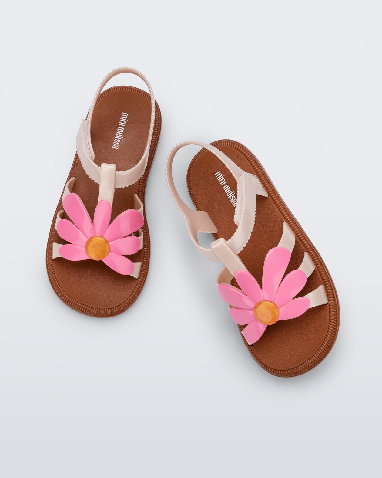 Top view of a pair of pink Hip Bloom kids sandals with pink flower