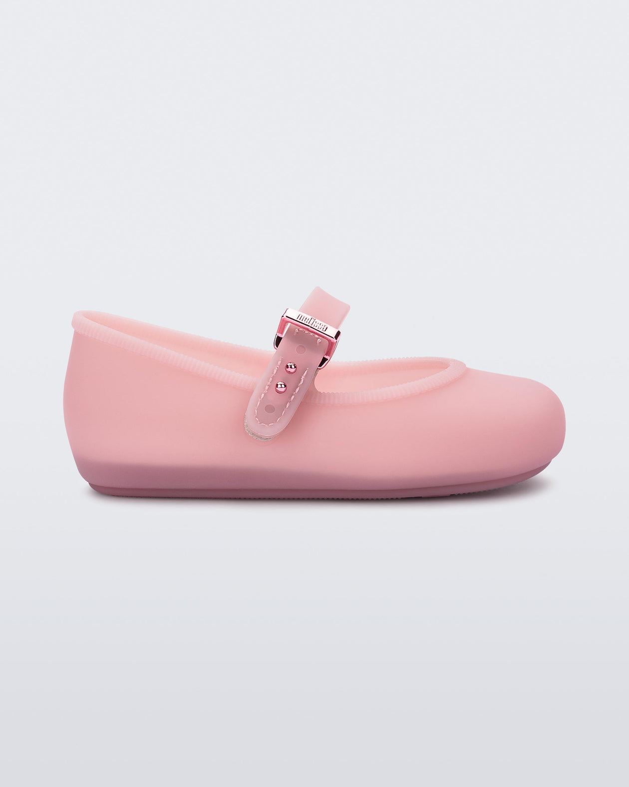 Side view of a milky pink Soft Ballerina baby flats