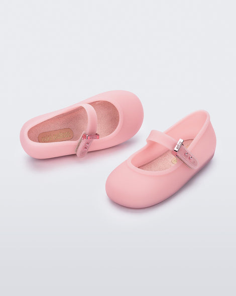 Top and angled view of a pair of milky pink Soft ballerina baby flats