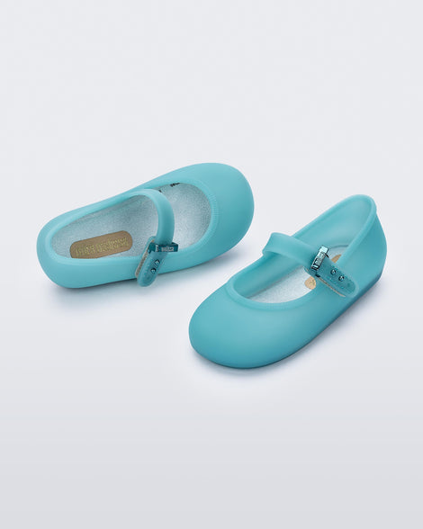 Top and angled view of a pair of milky blue Soft Ballerina baby flats