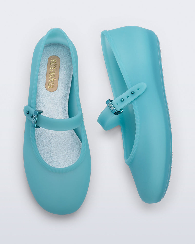 Top and side view of a pair of milky blue Soft Ballerina kids flats