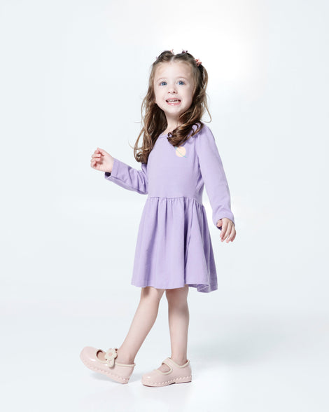 Child model in a purple dress wearing a pair of pink Hip Ballerina flats
