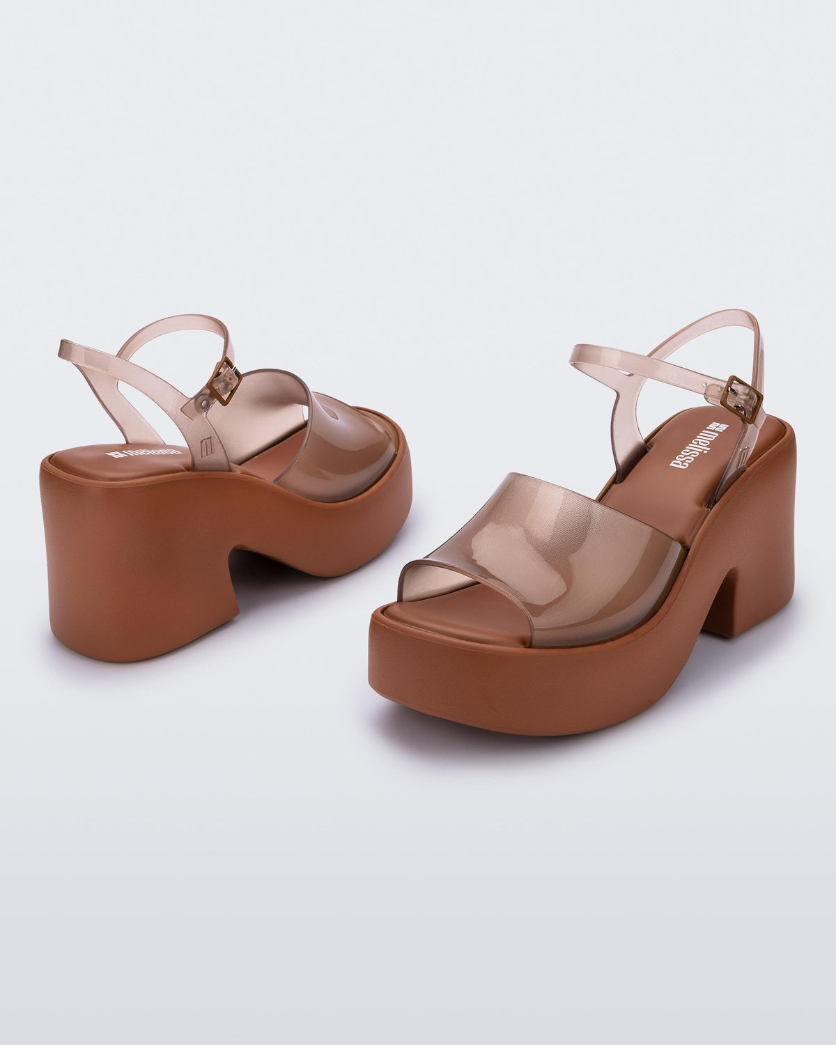 Back and angled view of a pair of clear brown Lina platform heels