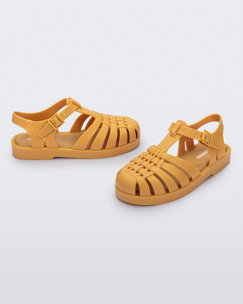 Front and back angled view of a pair of matte caramel Possession kids fisherman sandals.