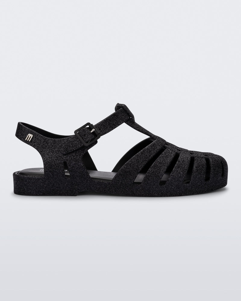 Side view of a glitter black Possession fisherman sandal