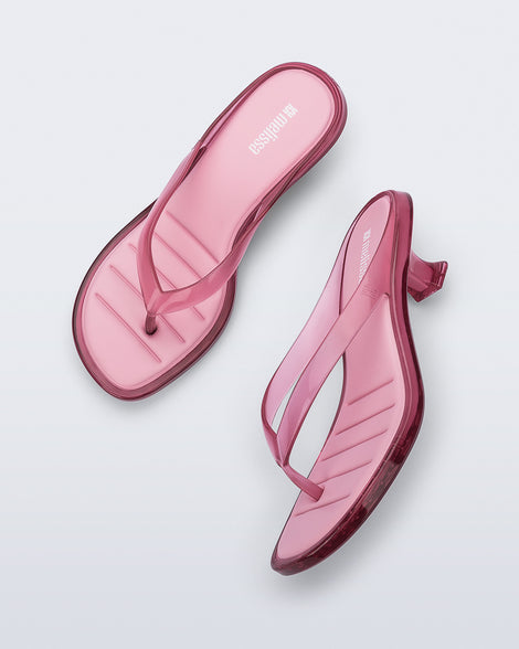Top and side view of a pair of pink Flip Flop Kitten Heels with clear pink straps