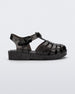 Side view of a Mini Melissa Possession. baby sandal in glitter black with velcro buckle closure on the ankle strap