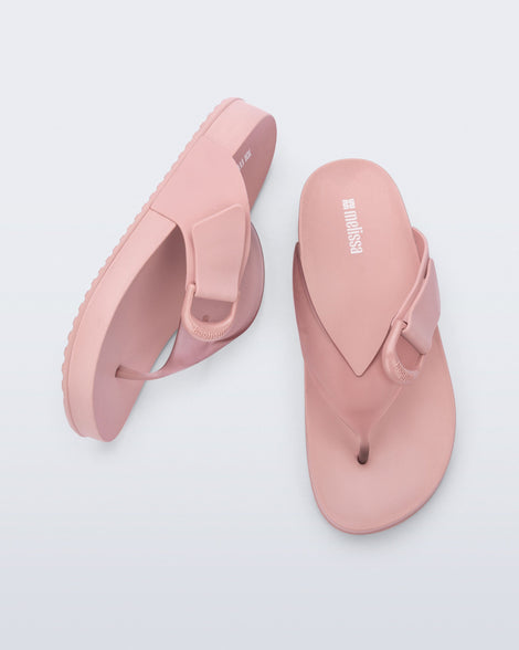 Top and side view of a pair of pink Cozy Thong flip flops