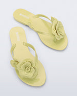 Top view of a pair of green Harmonic Petals flip Flop with green flowers on top