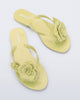 Top view of a pair of green Harmonic Petals flip Flop with green flowers on top