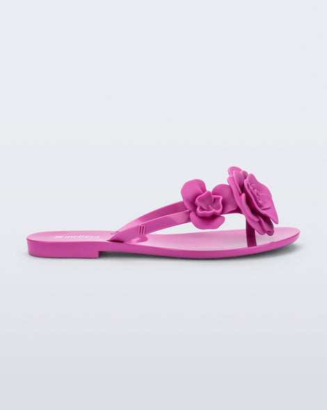 Side view of a pink Harmonic Petals flip Flop with pink flowers on top