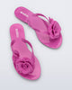 Top view of a pair of pink Harmonic Petals flip Flop with pink flowers on top