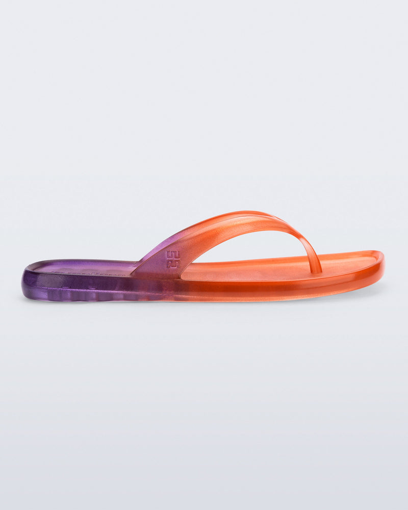 Side view of a orange/purple Beachwear flip flop