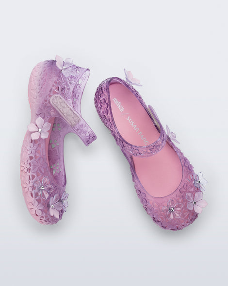 Top and side view of a pair of pink Melissa + Susan Fang Luna Bloom flats with flower adornments