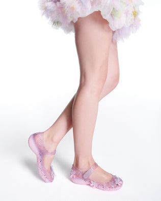 Model's legs wearing a pair of pink Melissa + Susan Fang Luna Bloom flats with flower adornments