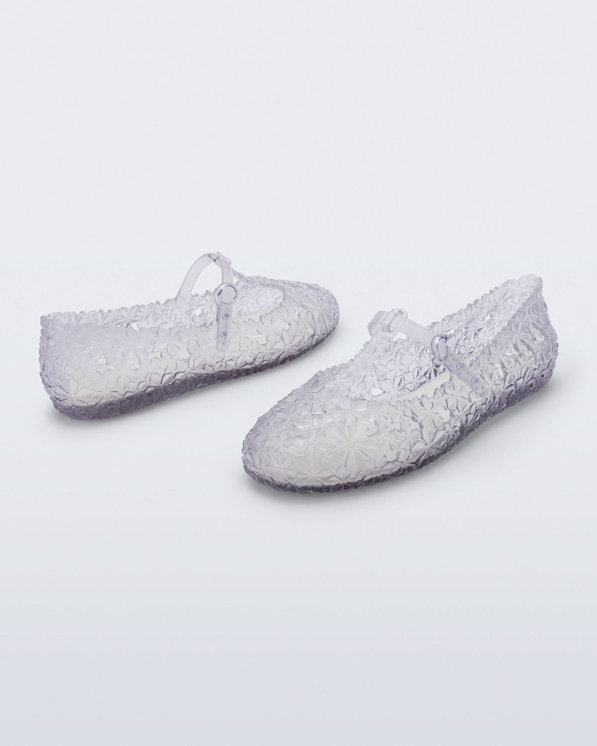 Back and side angled view of a pair of clear Melissa + Susan Fang Daphnis Ballerinas with t-top strap