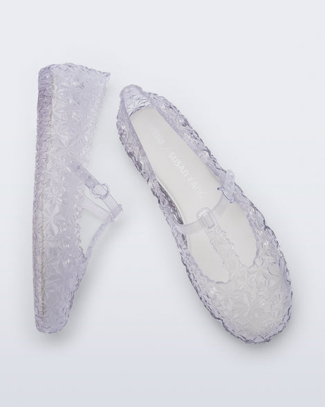 Top and side view of a pair of clear Melissa + Susan Fang Daphnis Ballerinas with t-top strap