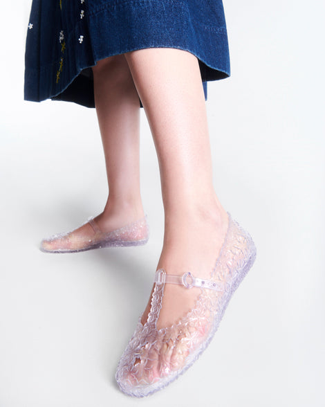 Model's legs wearing a pair of clear Melissa + Susan Fang Daphnis Ballerinas with t-top strap