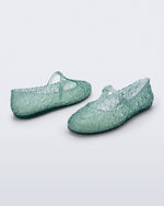 Back and side angled view of a pair of clear green Melissa + Susan Fang Daphnis Ballerinas with t-top strap