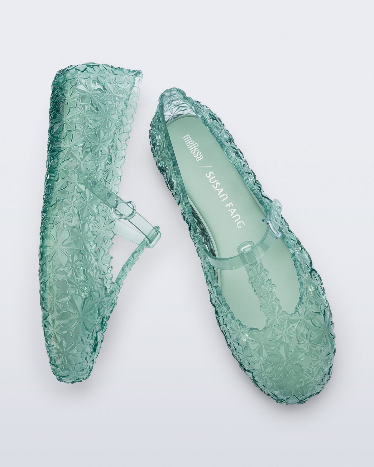 Top and side view of a pair of clear green Melissa + Susan Fang Daphnis Ballerinas with t-top strap