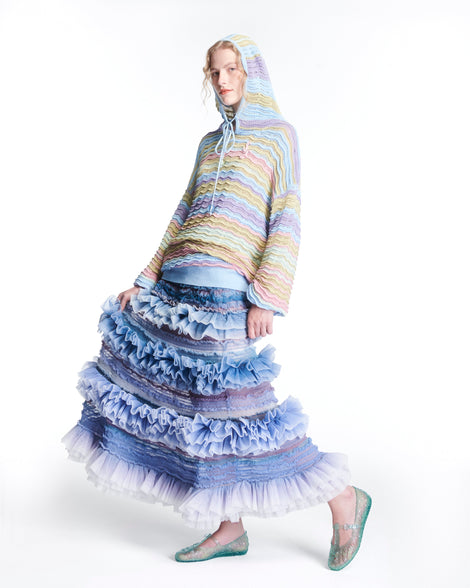 Model in a sweater and long skirt wearing a pair of clear green Melissa + Susan Fang Daphnis Ballerinas with t-top strap