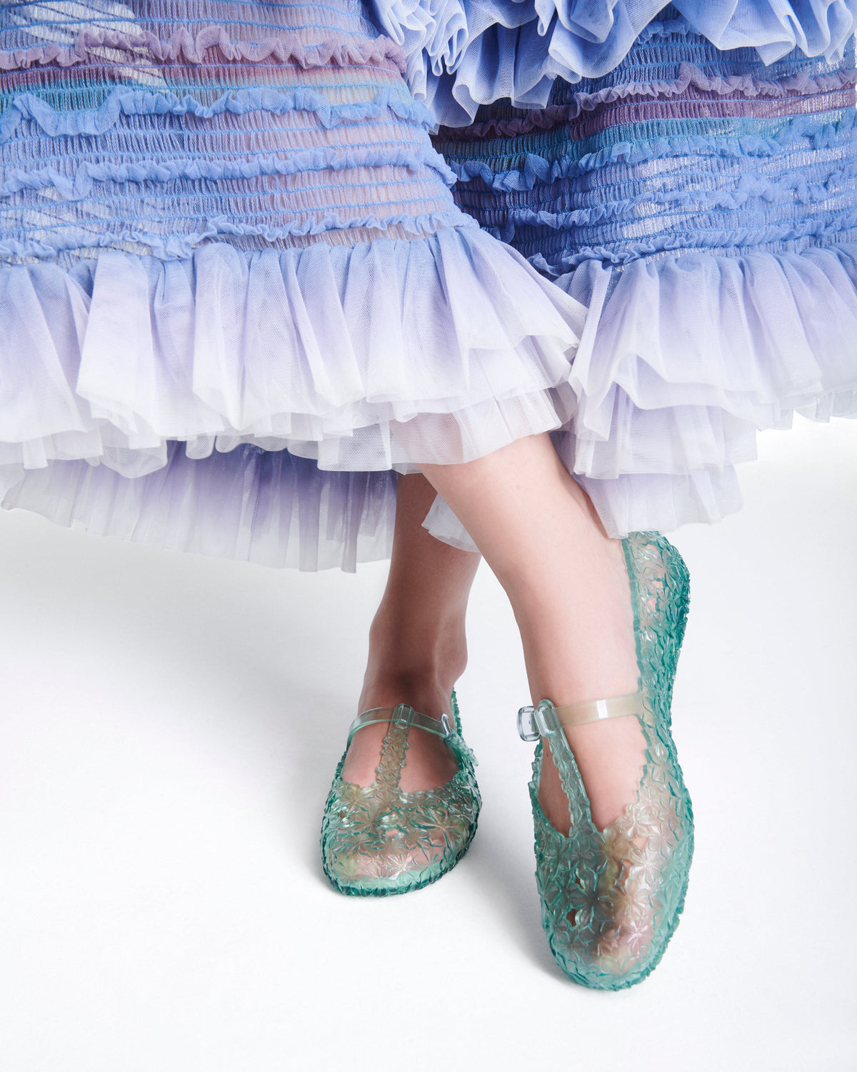 Model's legs wearing a pair of clear green Melissa + Susan Fang Daphnis Ballerinas with t-top strap