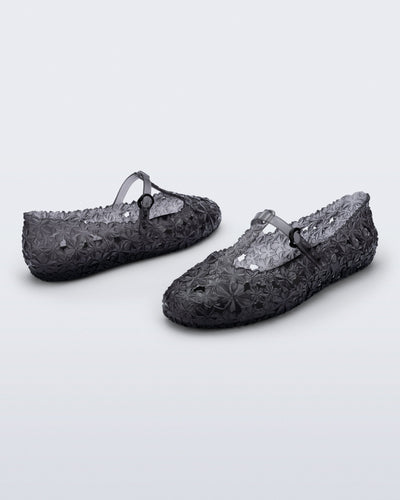 Back and side angled view of a pair of clear black Melissa + Susan Fang Daphnis Ballerinas with t-top strap